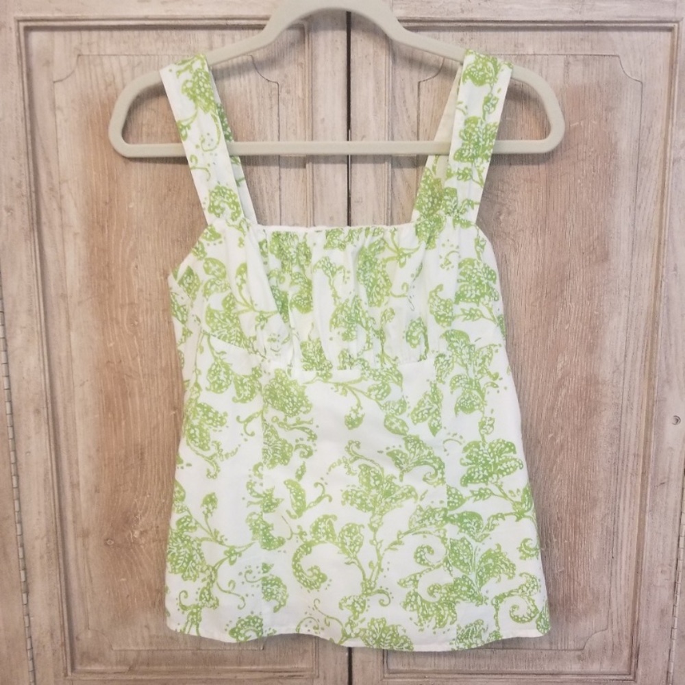 Harold’s green and white sleeveless top